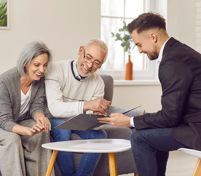 senior couple with a man with paper